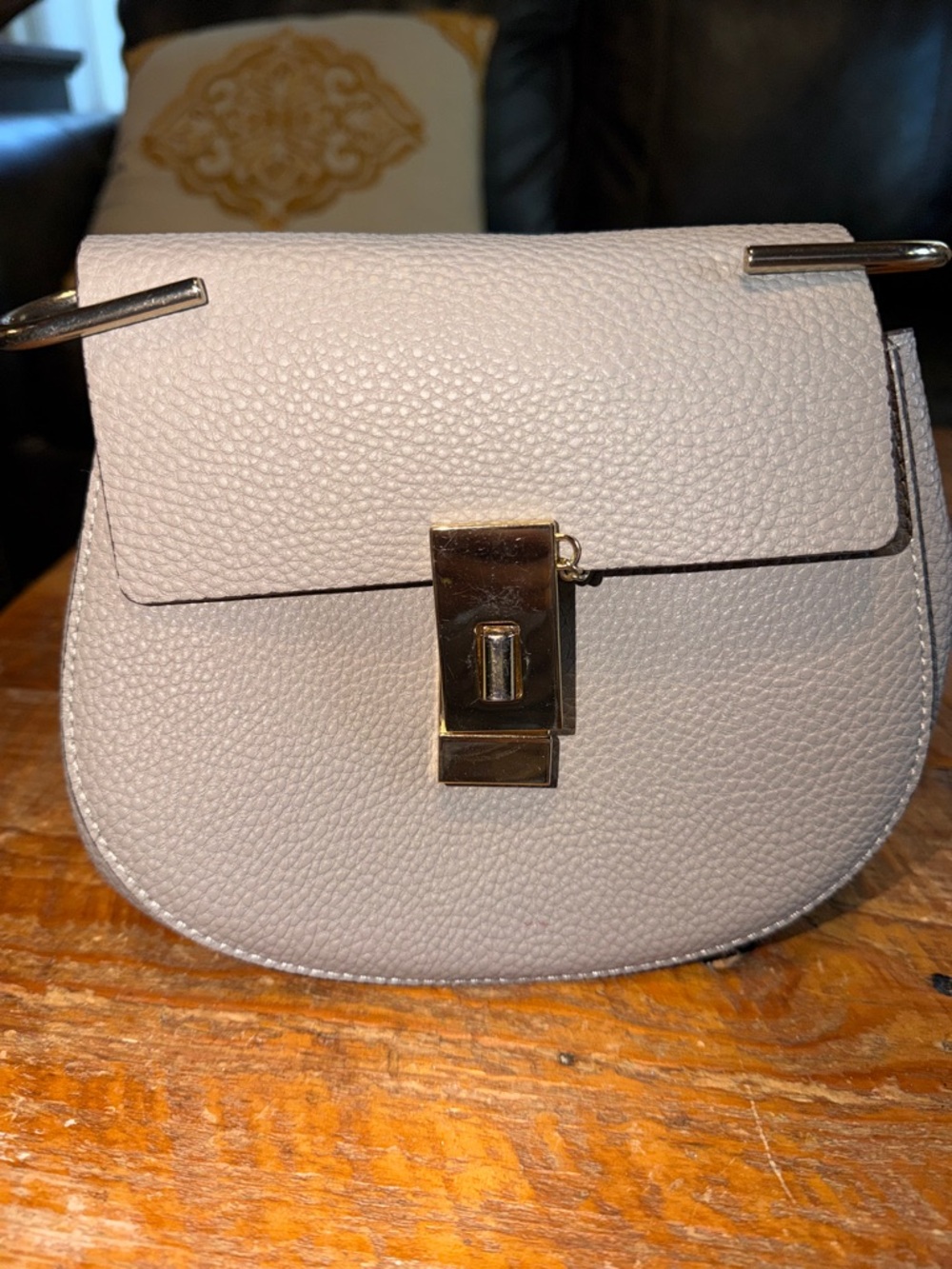 Pebbled Saddle Crossbody Bag in Light Gray with Gold-Tone Lock